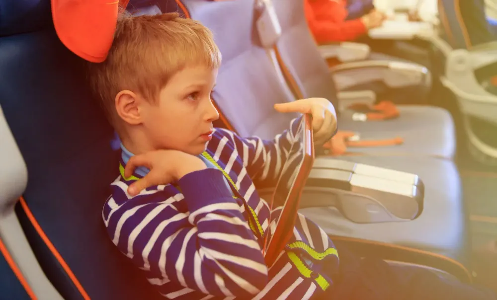 child on plane for airline family seating.